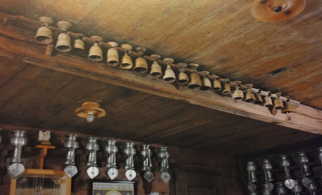 Wine goblets hanging from a rack in a tavern in Switzerland
